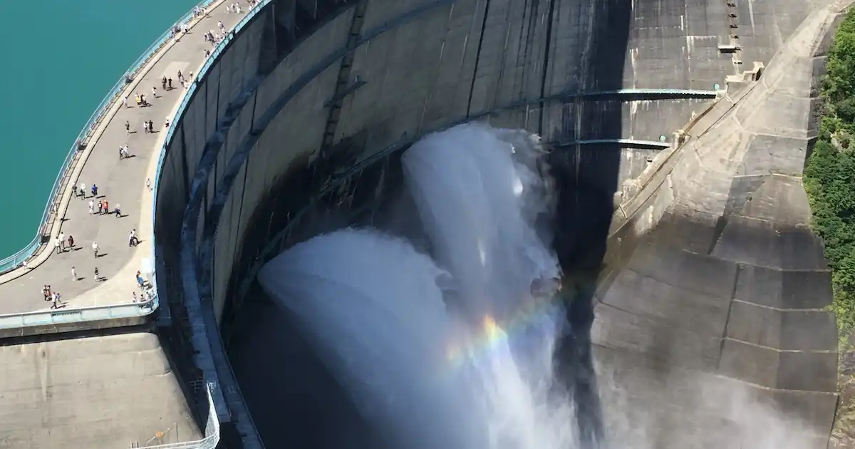 People walking on top of a giant hydroelectric dam in Nagano, Japan